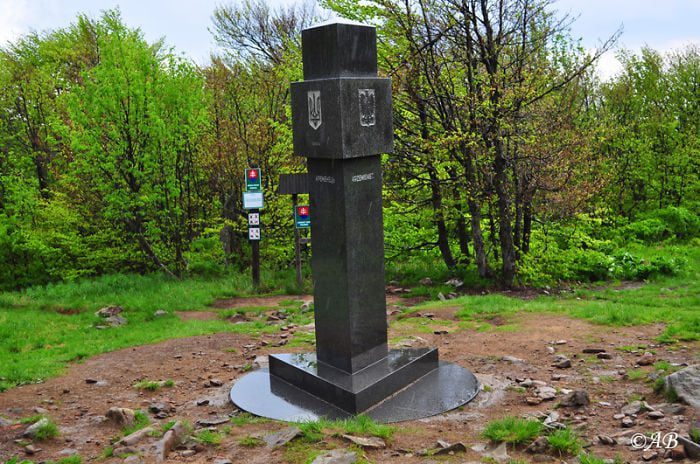 grey stone tripoint marker on mount krzemieniec where poland, ukraine, and slovakia meet