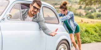 woman pushing car