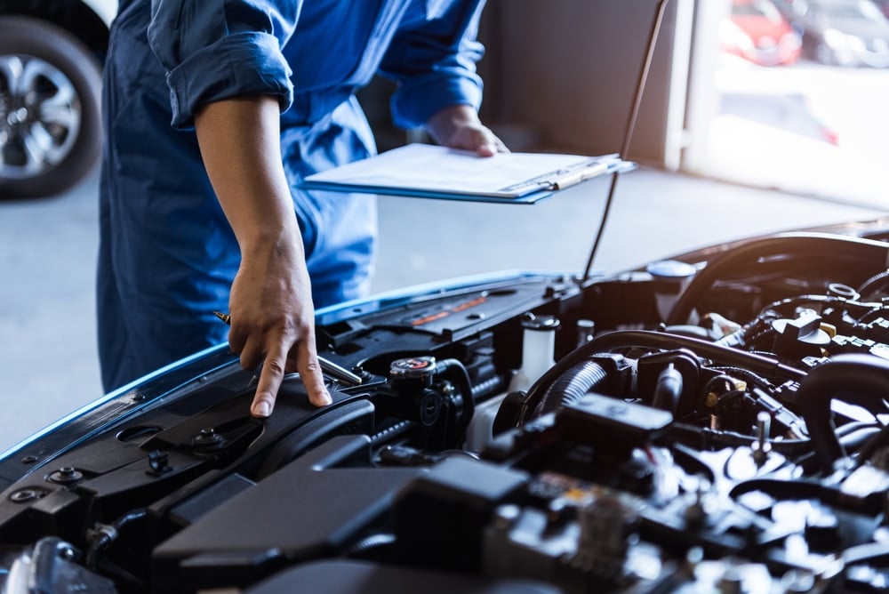 Mechanic inspecting vehicle during a full car service