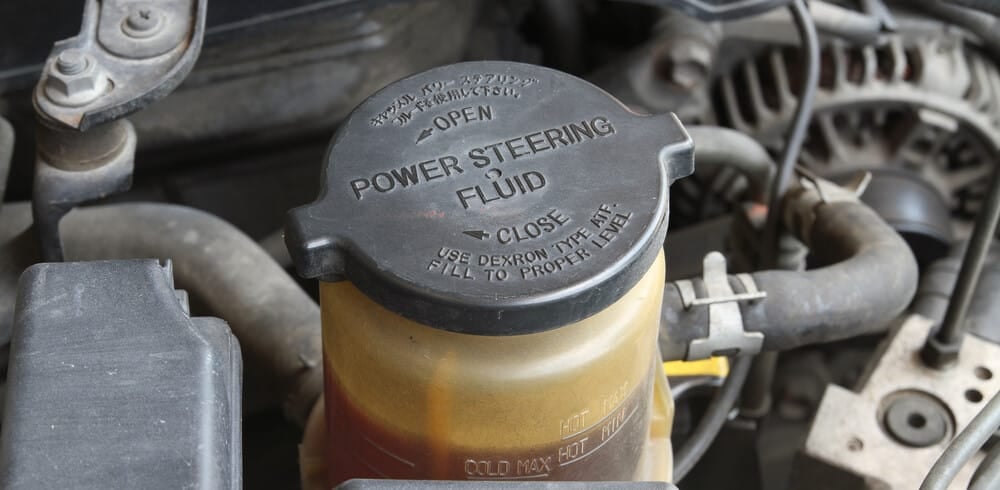Power steering fluid reservoir and fluid type reference