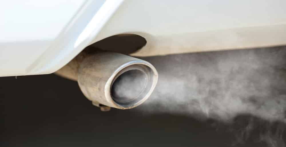Condensation and visible exhaust vapor from a vehicle tailpipe